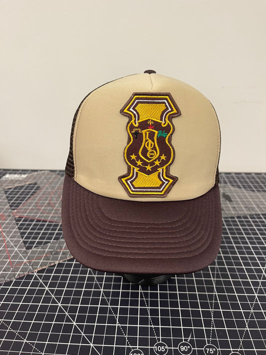 Iota Shield Emblem Trucker Hat – Tan/Brown Edition