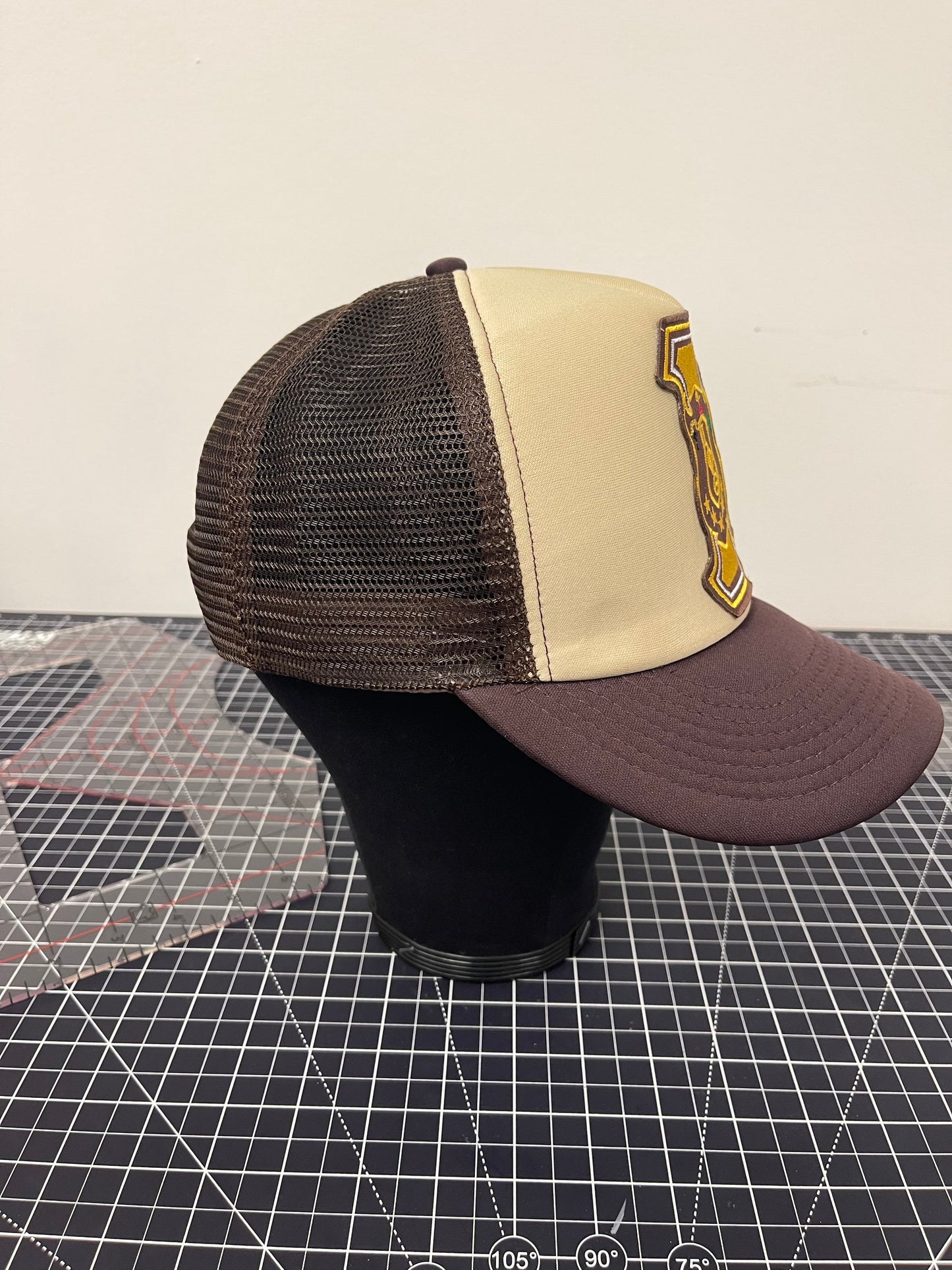 Iota Shield Emblem Trucker Hat – Tan/Brown Edition
